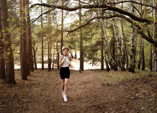 front-view-woman-running-nature_23-2149486933