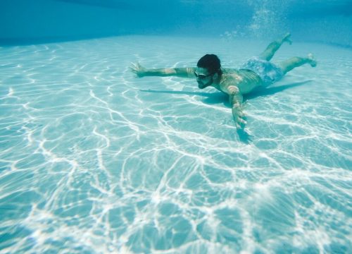 guy-diving-swimming-pool_23-2147664447