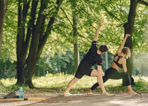 young-sportive-couple-doing-yoga-fitness-people-summer-park_1157-40150